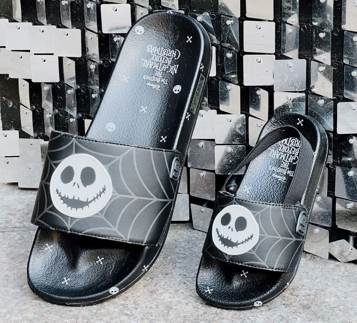Two sandal slides with Jack Skellington on the front sitting next to each other