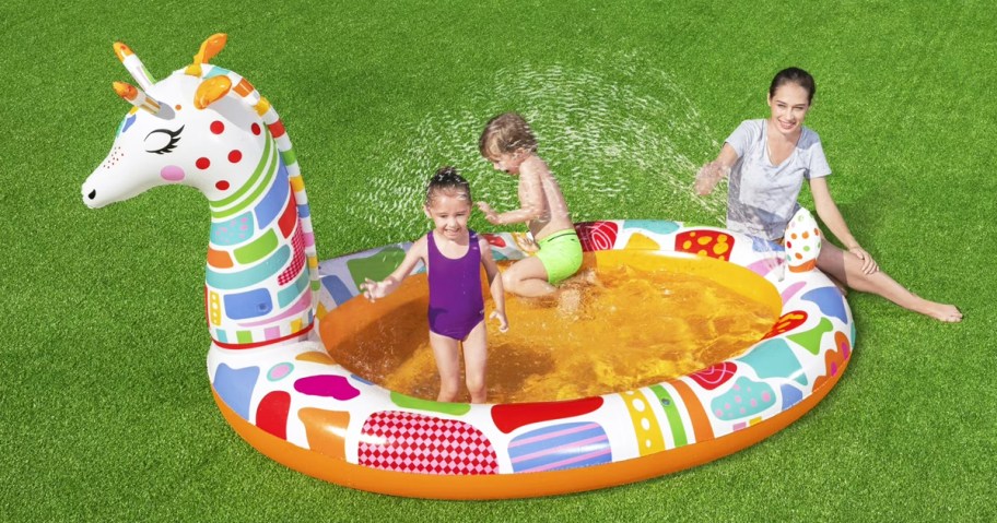 kids in a colorful giraffe inflatable pool