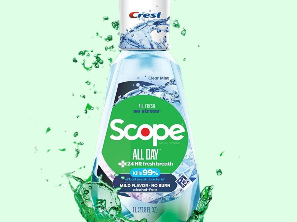 bottle of Crest Scope All Day Mouthwash with mouthwash splashing around it