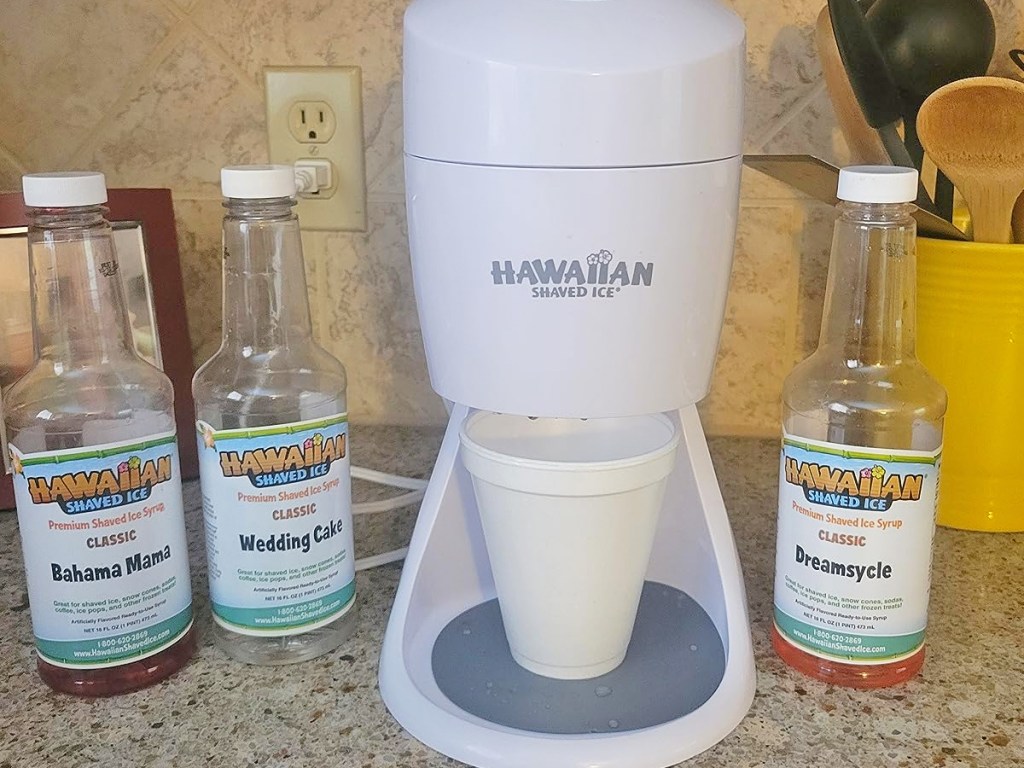 Hawaiian Shaved Ice Machine on kitchen counter near bottles of syrups