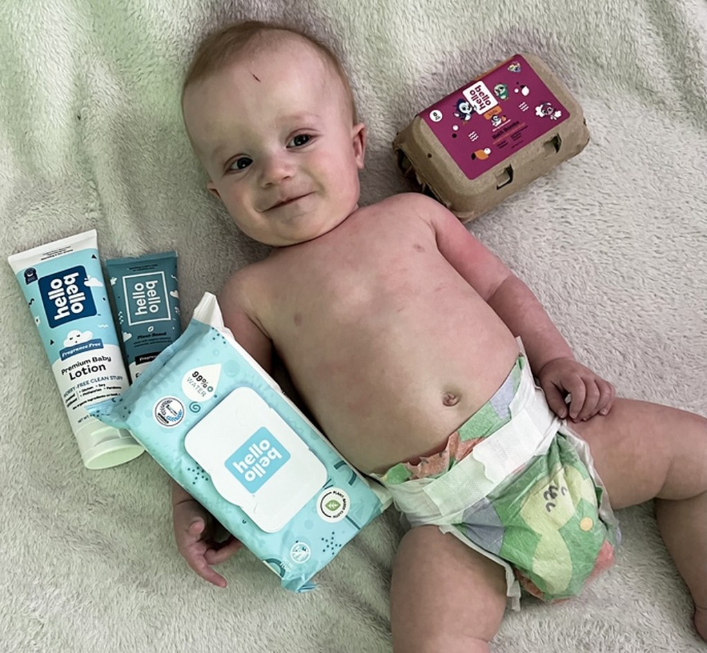 baby surrounded by hello bello products