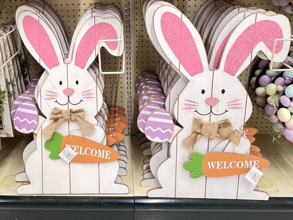 large wood white Easter rabbit sign holding a carrot that says "welcome"