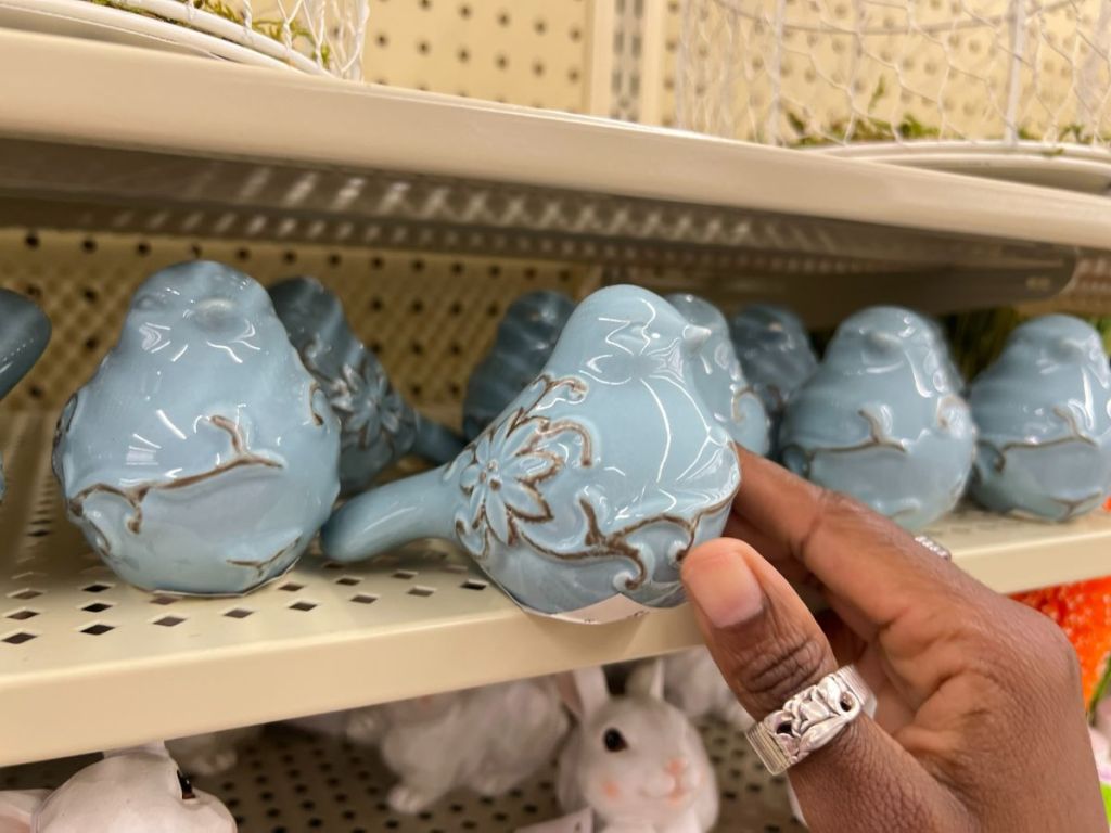 blue and brown rustic ceramic bird on shelf