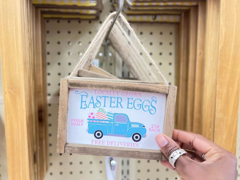 Small wooden hanging sign with blue truck that says Easter Eggs