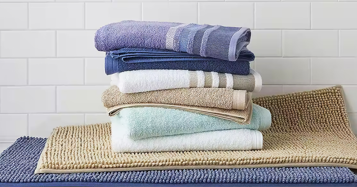 stack of folded bath towels on top of bath mats