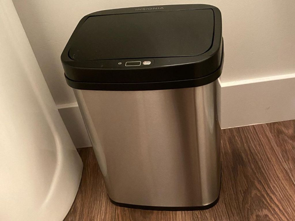 Stainless steel and black trash can next to a sink