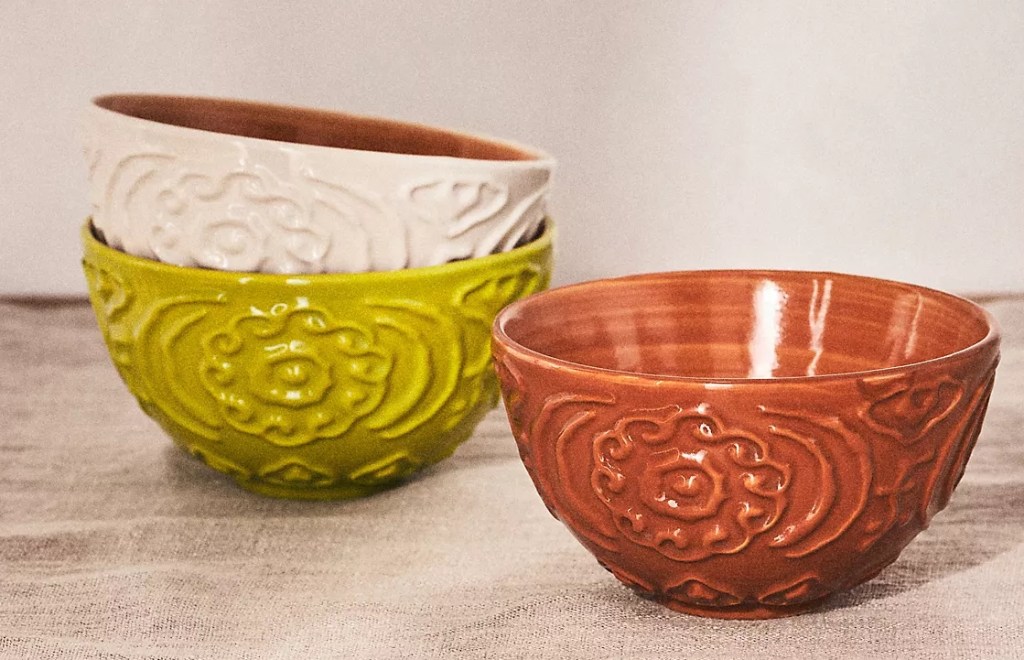 A green prep bowl with a white prep bowl in it and a red bowl next to it