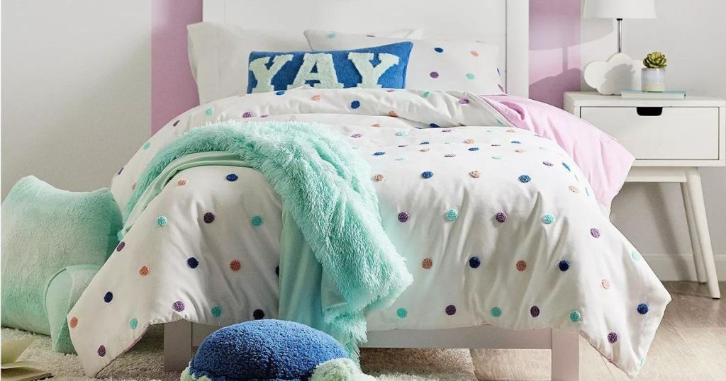 a child's room with polka dot comforter
