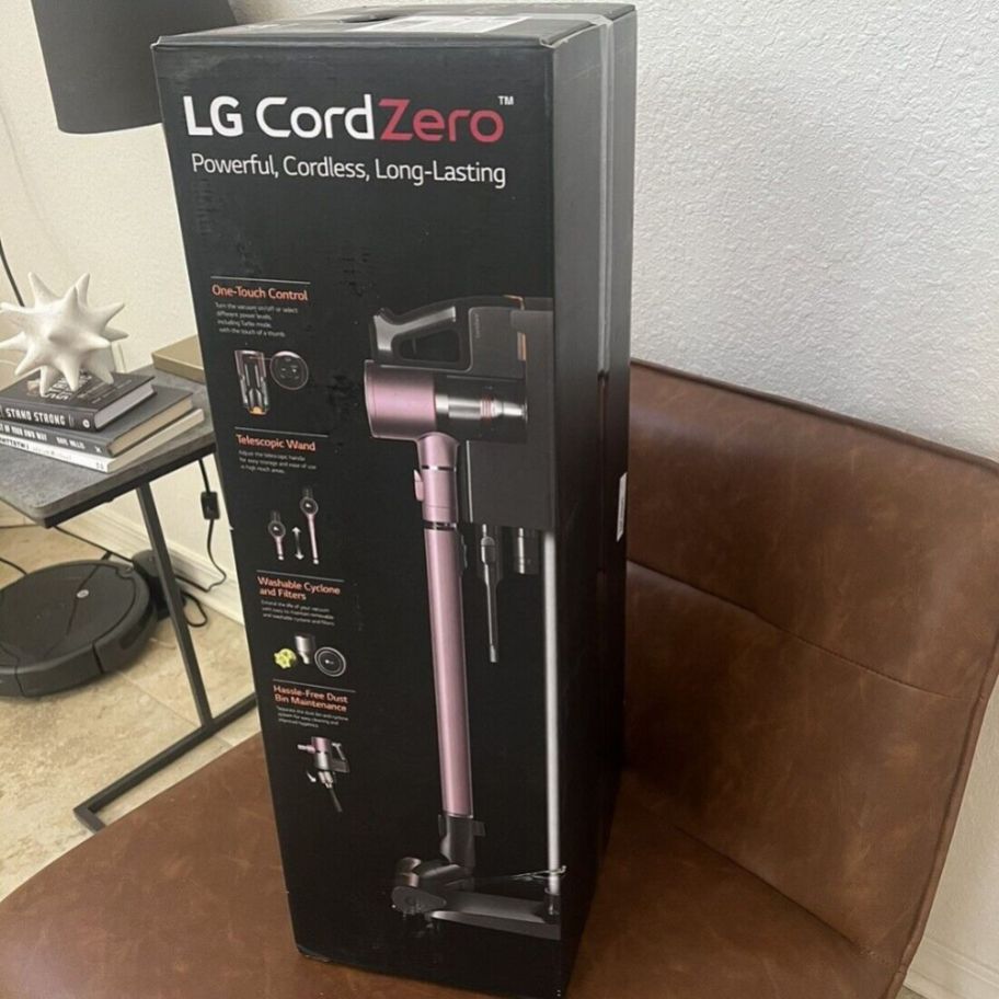 An LG Cord Zero in Rose Gold in a box sitting on a chair
