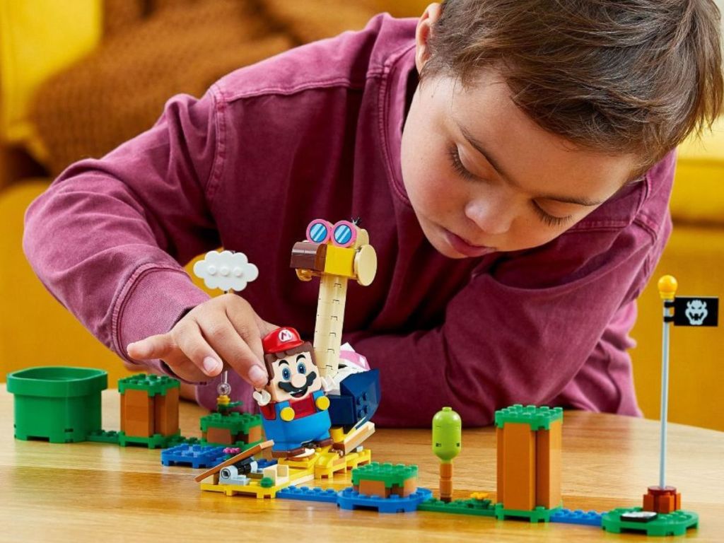 Boy playing with LEGO Super Mario Conkdor's Noggin Bopper Expansion Set