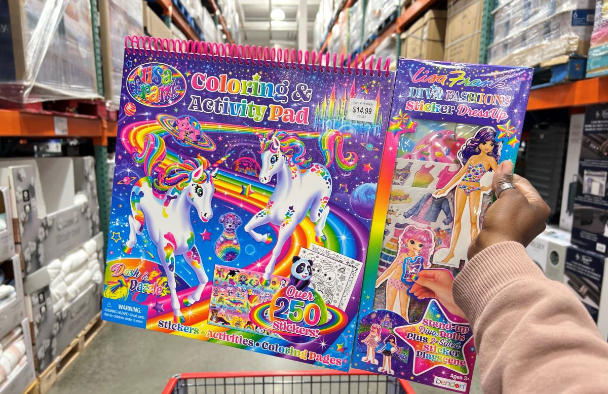 Hand holding a Lisa Frank Activity Pad in store