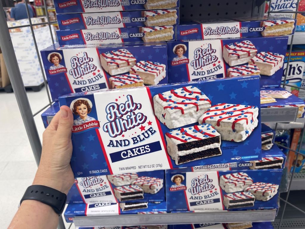 Hand holding a box of Little Debbie snack cakes