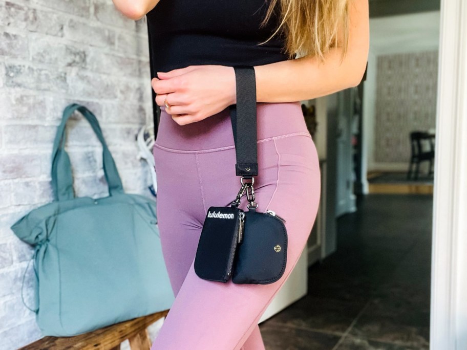 woman wearing Lululemon Wristlet in black