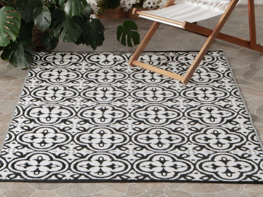 A Mainstays Rug in Navy Blue on a porch 