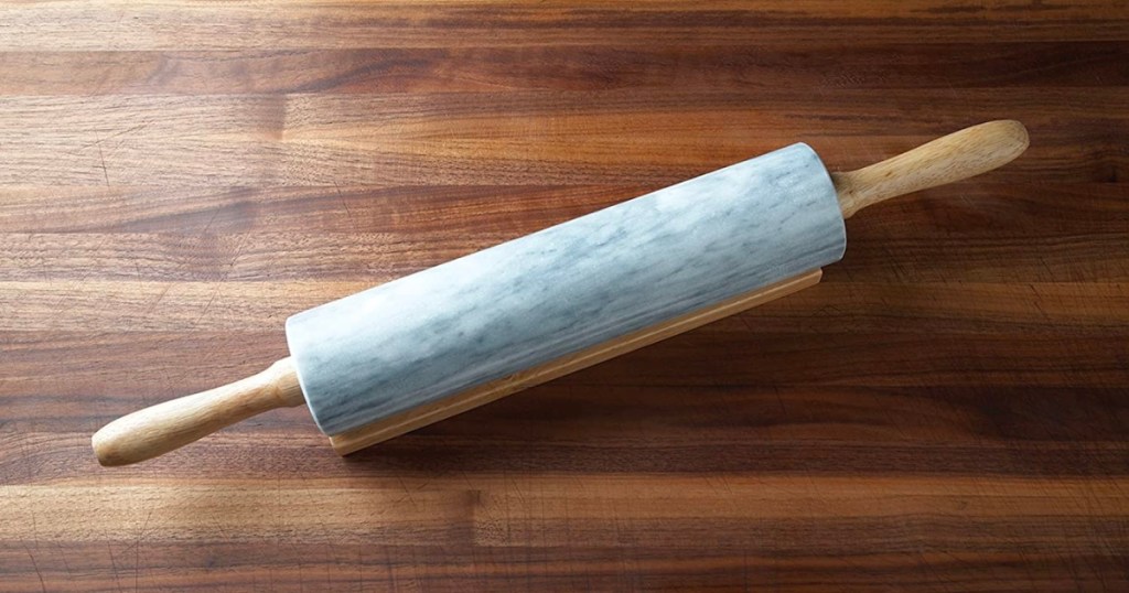 marble rolling pin with wooden base on table