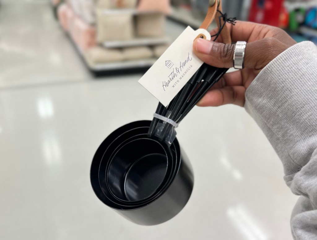 Woman holding Hearth and Hand measuring cups from Target since they are one of the Target Mothers Day gifts under 10 dollars