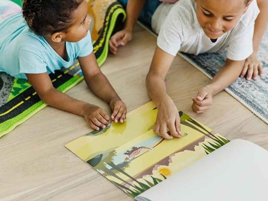 kids playing with the Melissa and Dough reusable sticker sheets on the floor