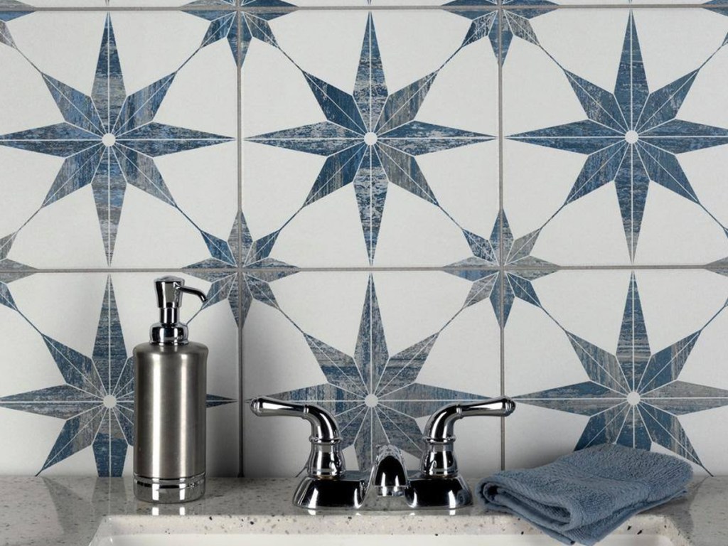 bathroom sink backsplash with white tiles with blue star pattern