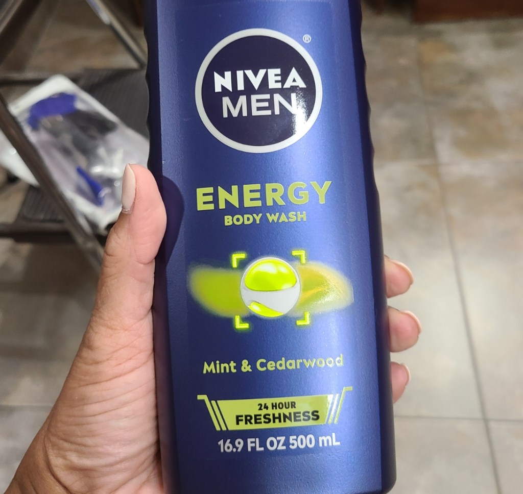 Hand holding a bottle of Nivea men's body wash