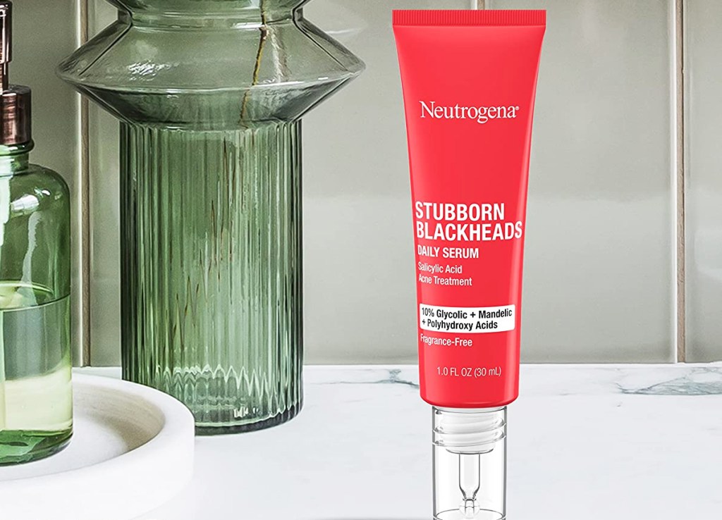 red bottle of Neutrogena Stubborn Blackheads Daily Acne Facial Serum on bathroom counter