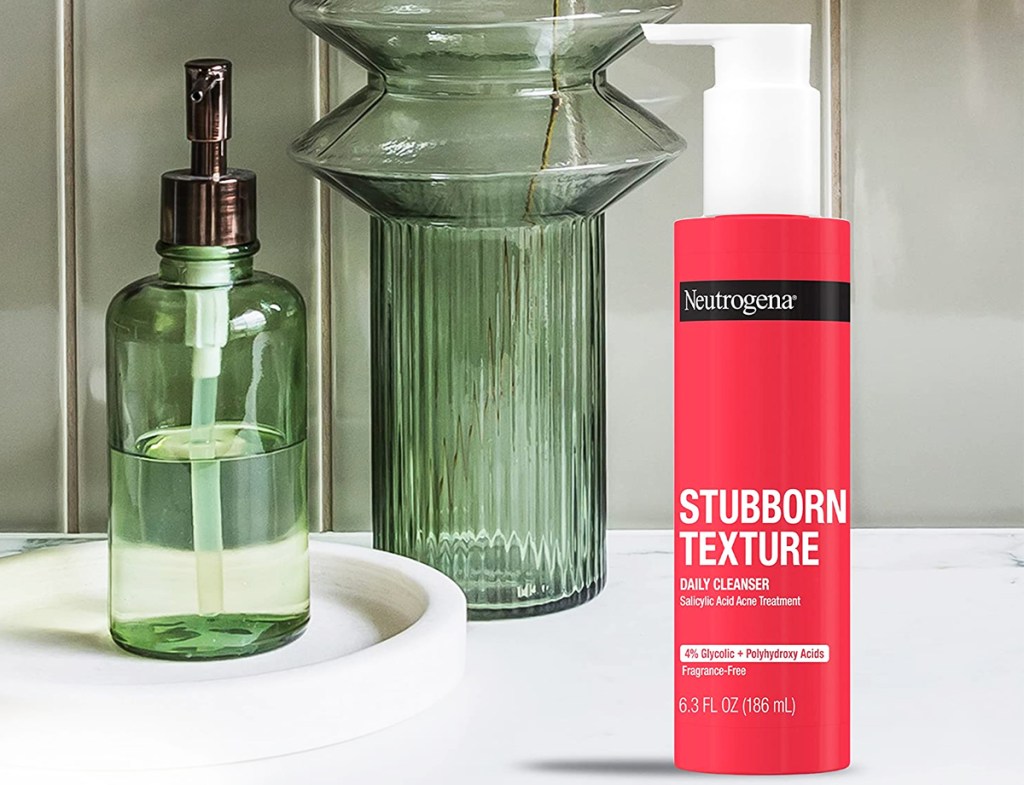 red bottle of Neutrogena Stubborn Texture Daily Acne Gel Facial Cleanser on bathroom counter