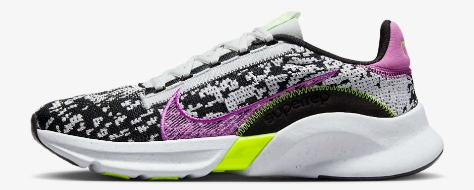 White and black Nike running shoe with purple and yellow accents