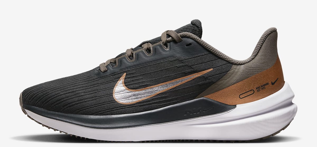 Black, gold, and brown women's Nike sneaker with a white sole