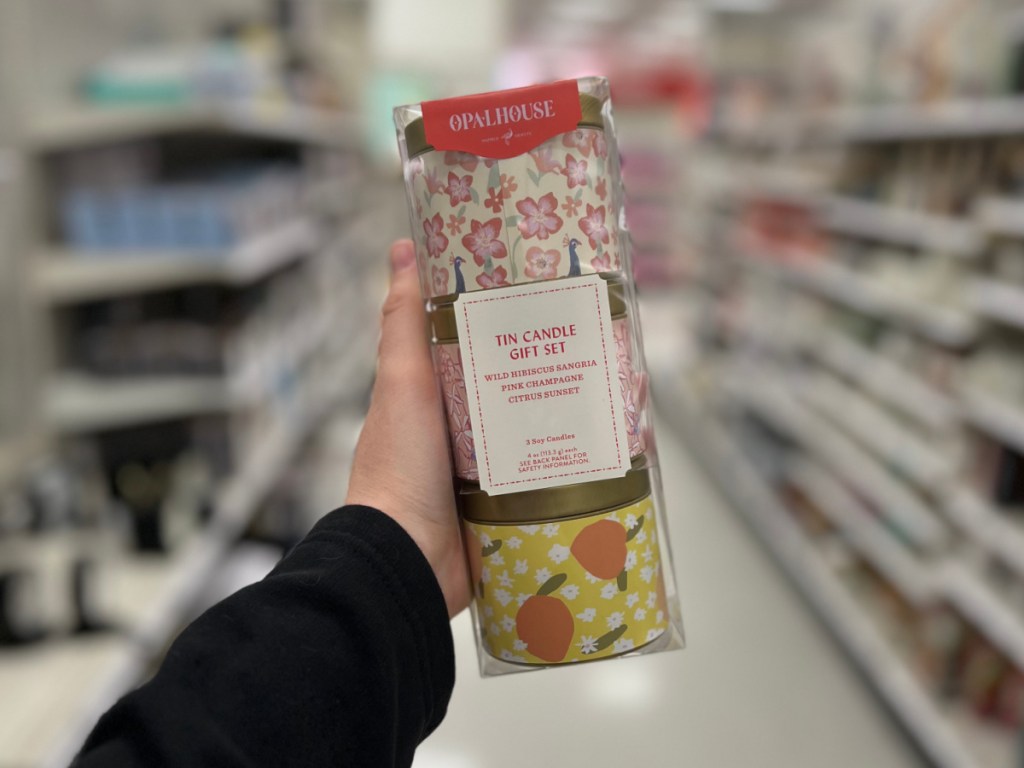 person holding Opalhouse Tin Candle Gift Set inside Target store