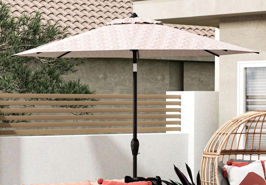 patio umbrella with white and red abstract print