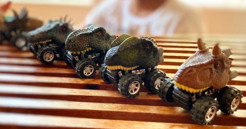 mini dinosaur car toys on a row