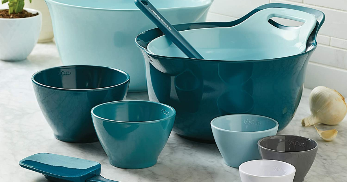 3 big blue mixings bowls with a hand and spout, and 5 smaller mixing bows and 2 spatulas on counter