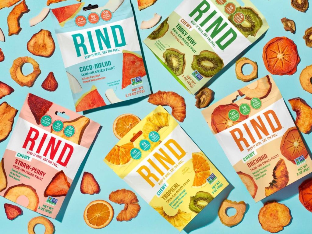 Multiple bags of RIND dried fruit placed on blue surface