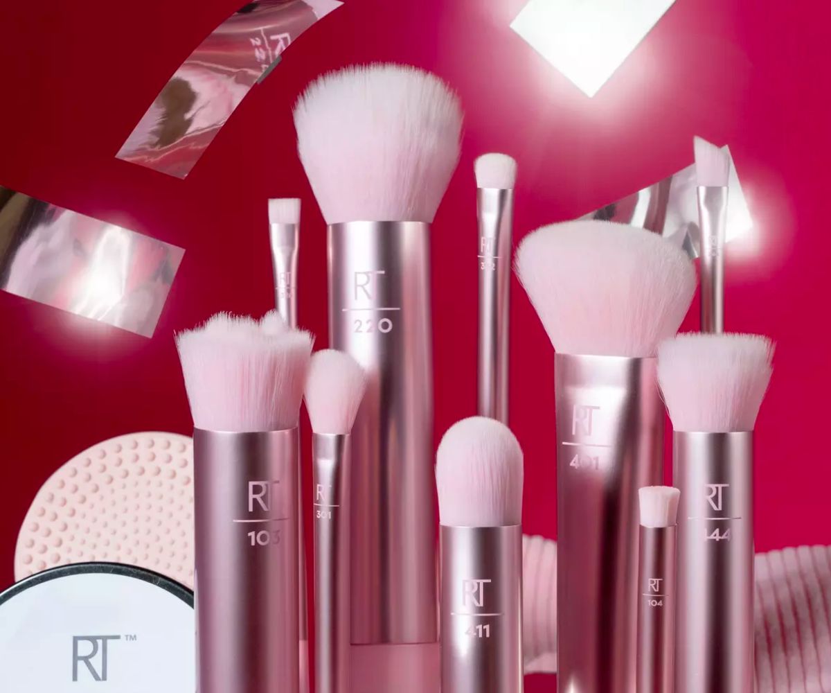 Real Techniques Shine of The Times 12-Piece Makeup Brush + Cleanse Gift Set displayed on a pink background