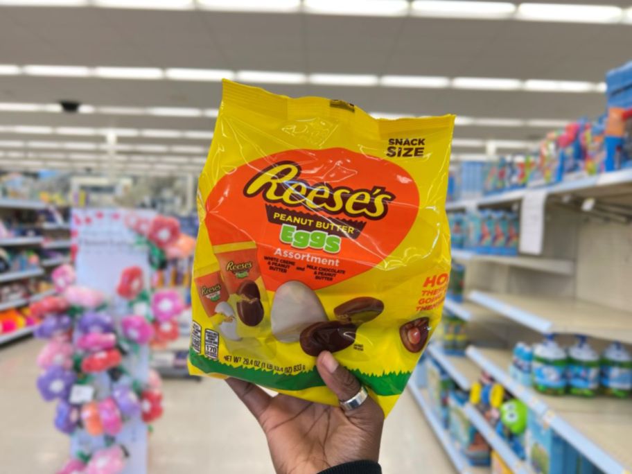 Hand holding a bag of Reese's Eggs