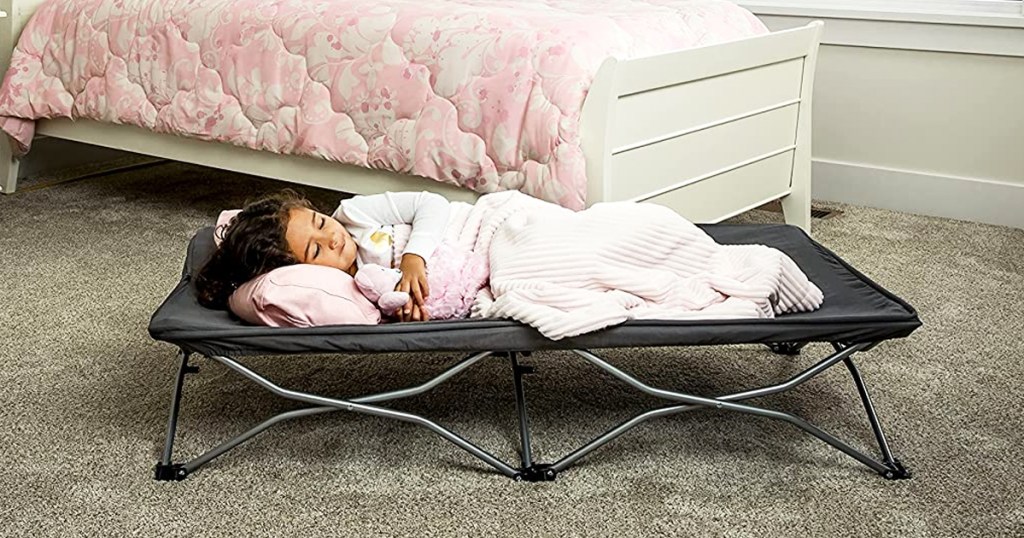 girl sleeping on a portable cot
