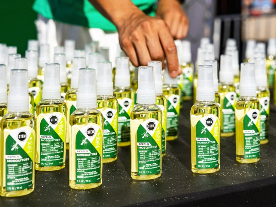 multiple bottles of STEM Mosquito Repellent on a table