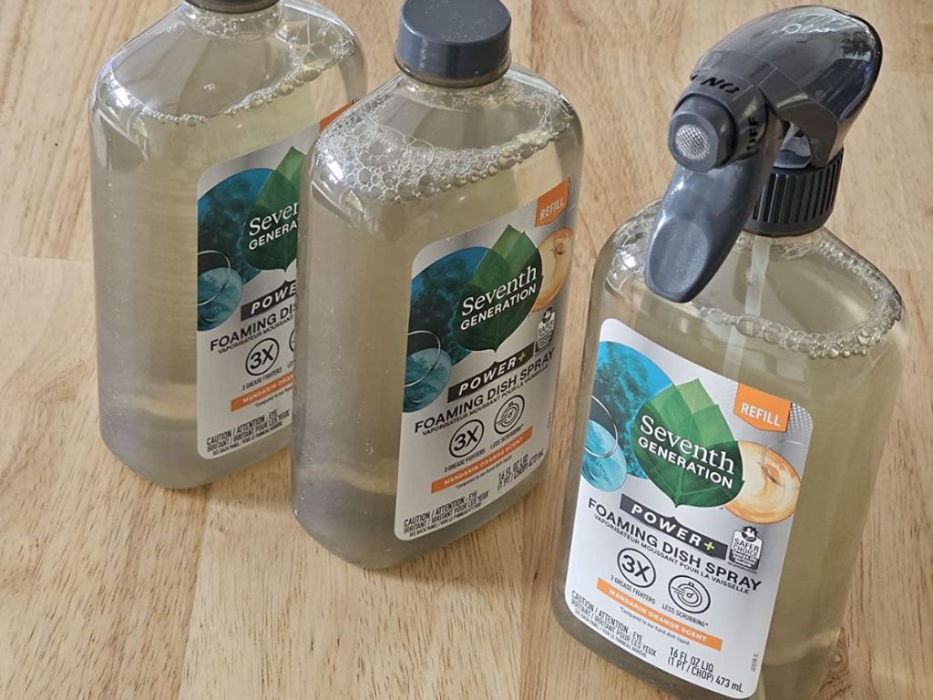 3 bottles of Seventh Generation foaming dish spray on wood surface
