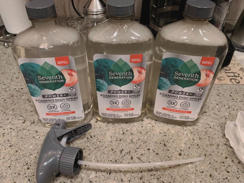 3 bottles of seventh generation apple scented on marble