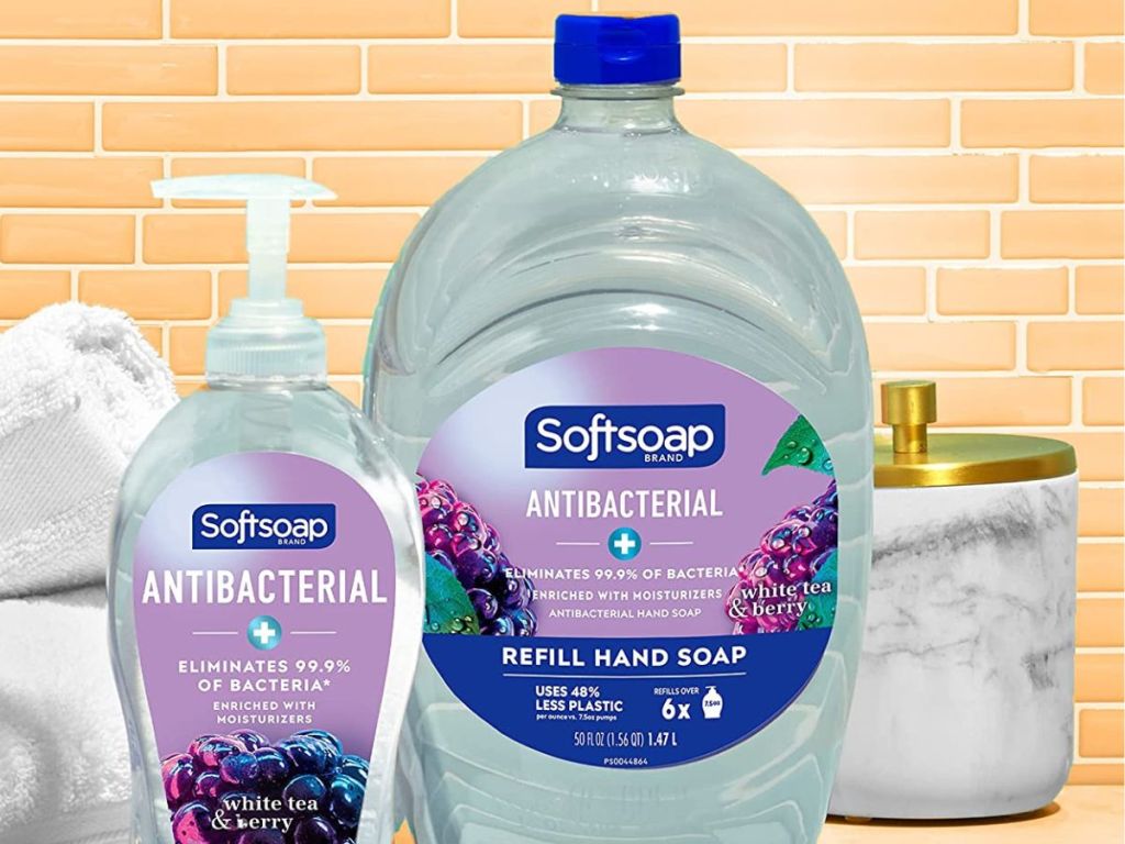 Softsoap refill bottle next to a regular bottle with towels behind them