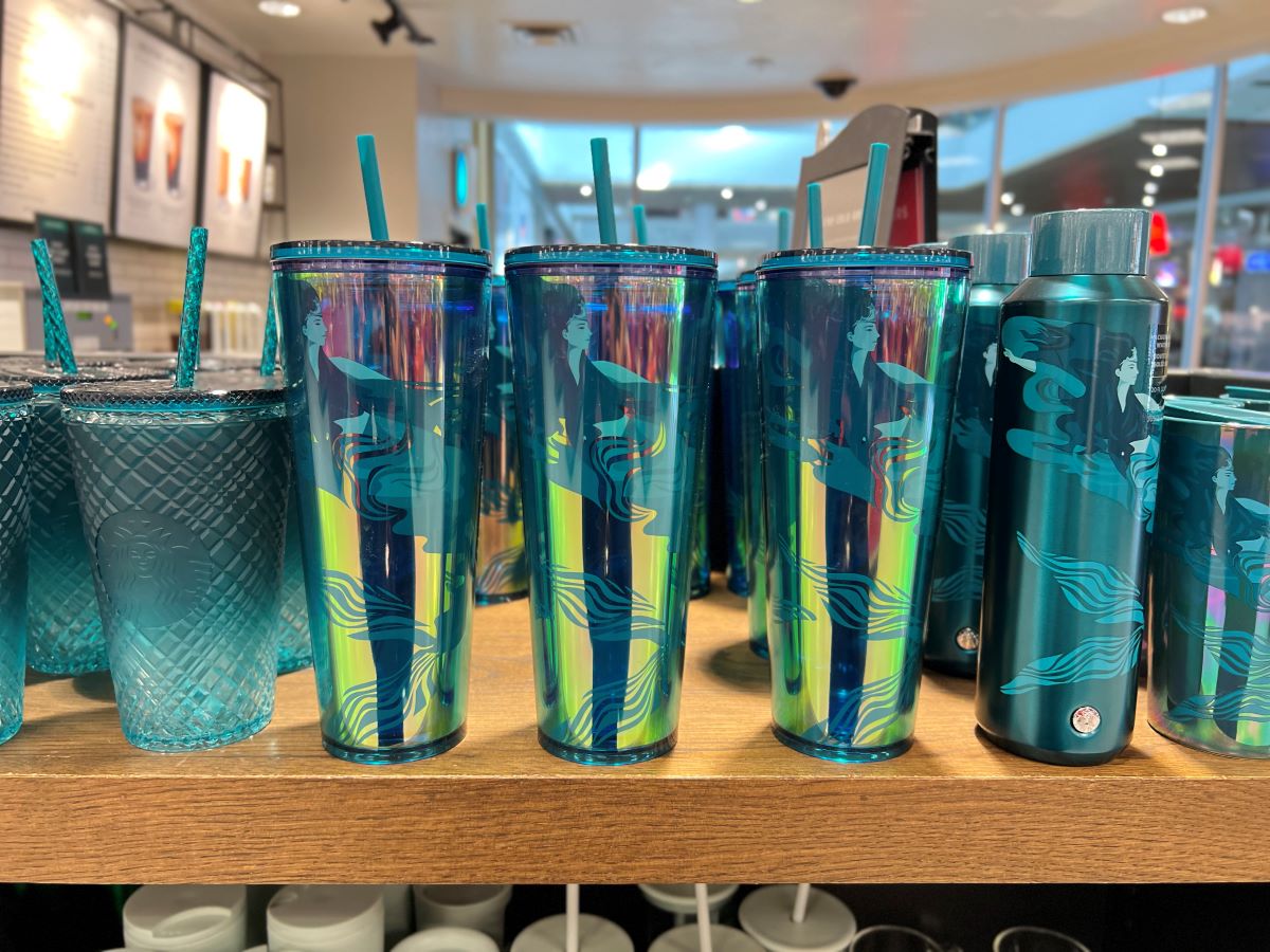 Row of reusable Starbucks cups on a shelf