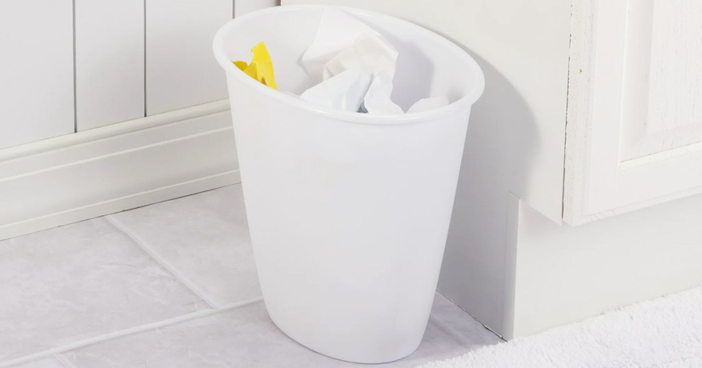 small white trash can in bathroom