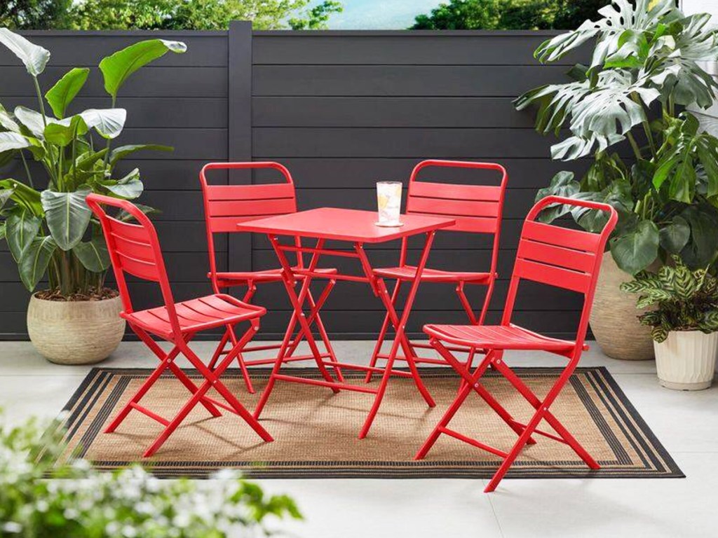 small red metal dining set on outdoor area rug