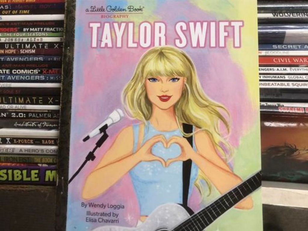 Taylor Swift Little Golden Book leaning against stacks of books