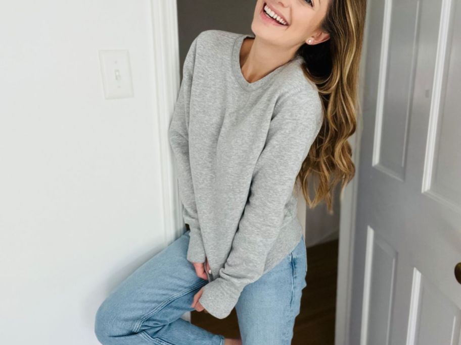 A woman wearing a gray Tek Gear Fleece Sweatshirt and jeans