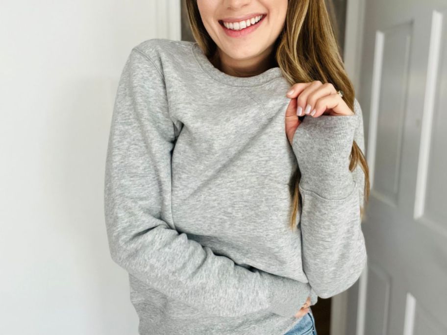 A woman wearing a gray Tek Gear Fleece Sweatshirt