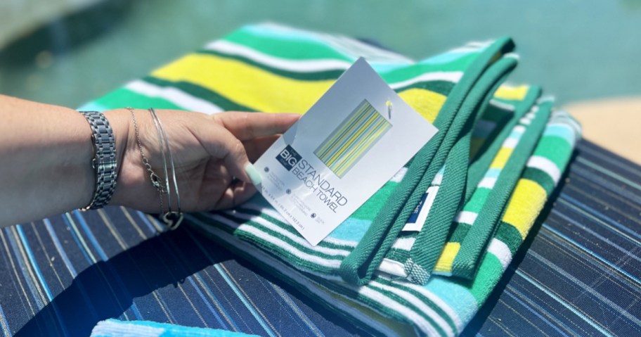 hand holding tag to big one beach towel