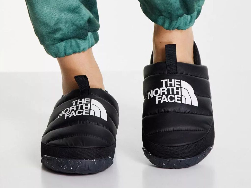 Person wearing black The North Face slippers