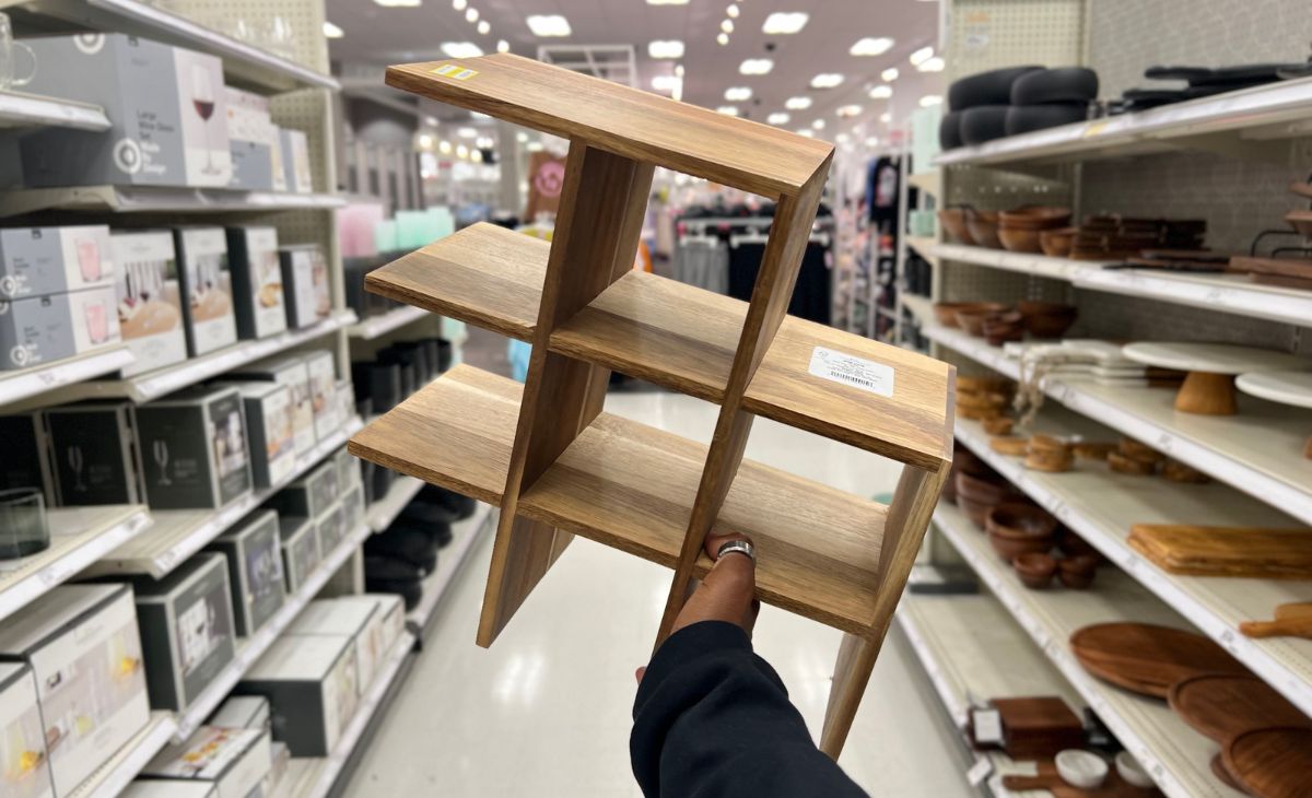 a woman's hand holding up a Threshold wine rack