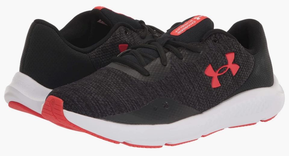Pair of black Under Armour sneakers with a white sole and red accents