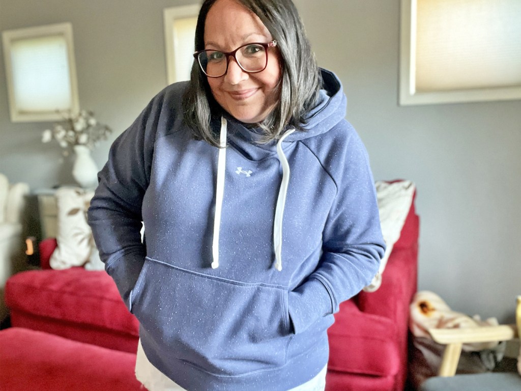 woman wearing a blue under armour hoodie and has her hands in the front pocket